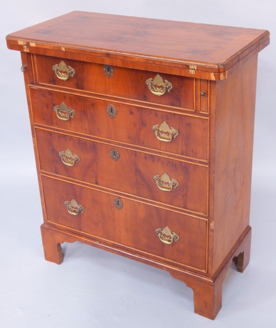 Appraisal: A mahogany and yew wood bachelor's chest the fold over