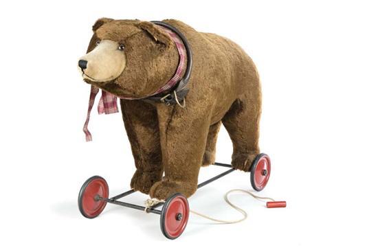 Appraisal: STEIFF BEAR ON WHEELS Large brown bear with leather collar