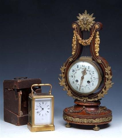 Appraisal: A FRENCH WALNUT LYRE CLOCK with painted enamel dial and