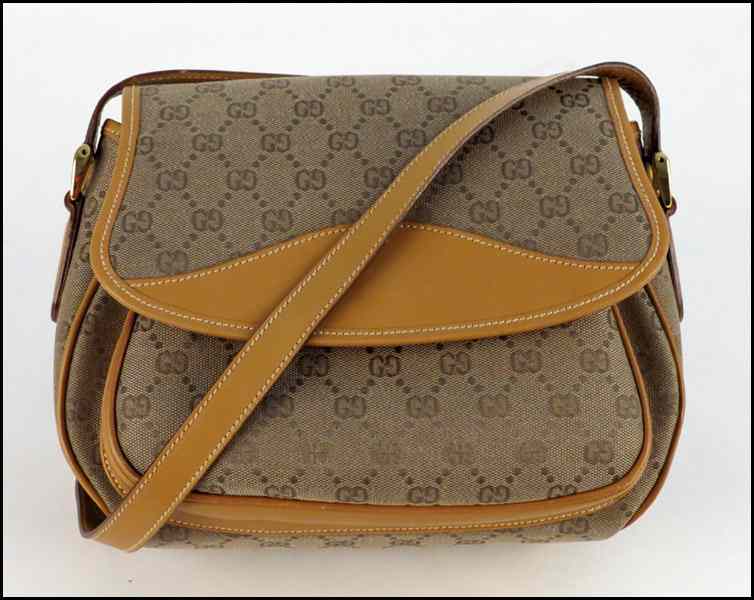 Appraisal: GUCCI MONOGRAMMED CANVAS AND LEATHER HANDBAG H '' W ''