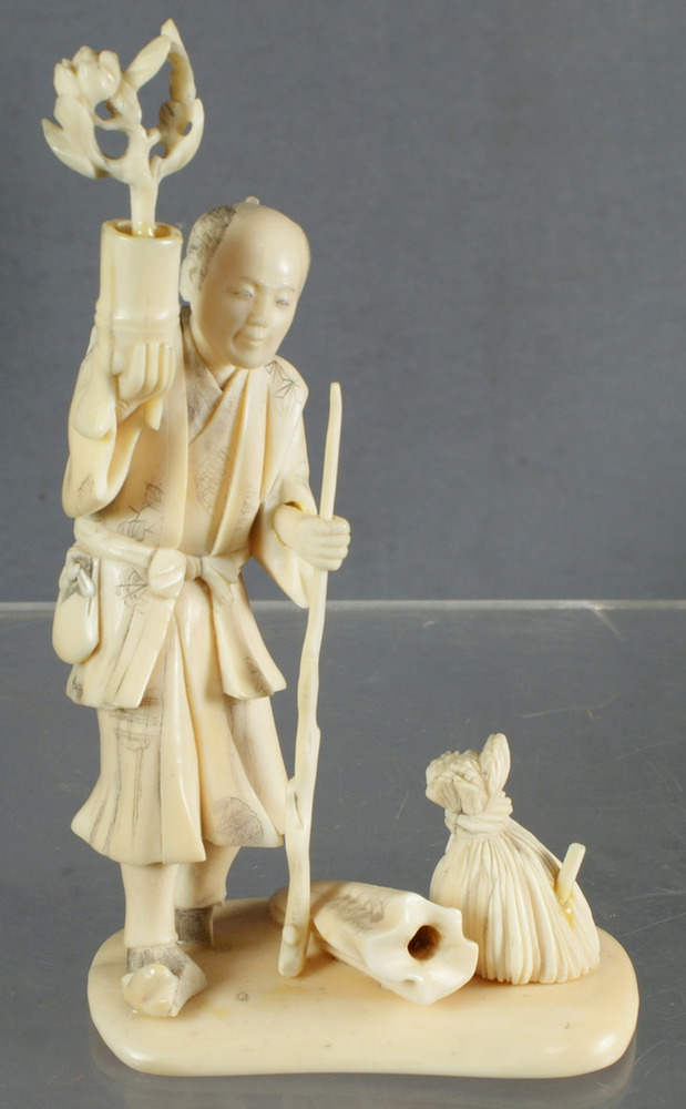 Appraisal: Carved ivory Japanese man holding flower pot tall splits in