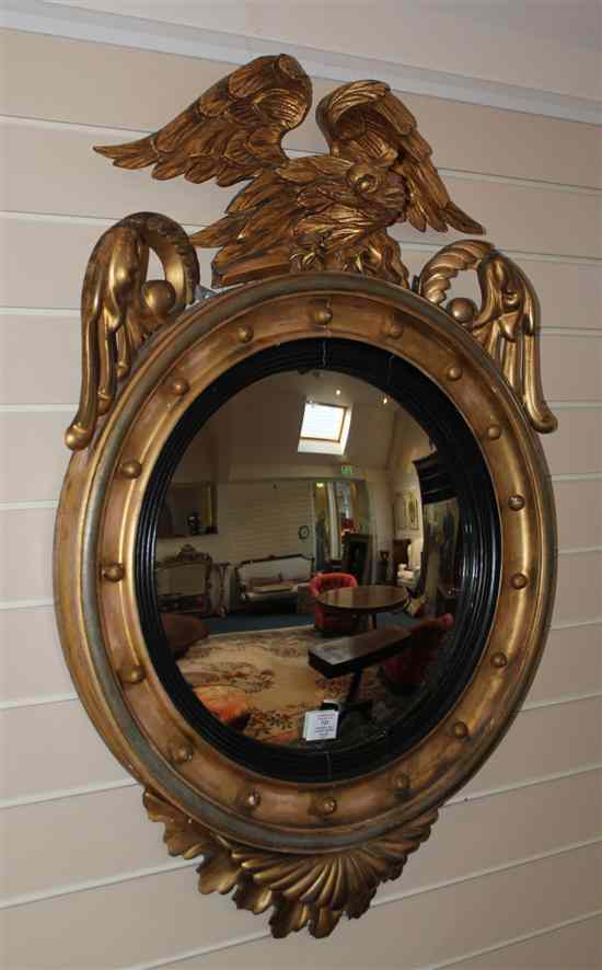 Appraisal: A Regency carved giltwood and gesso convex circular mirror with