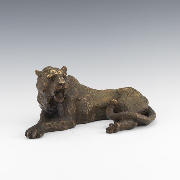 Appraisal: BRONZE LEOPARD x x Recumbent bronze leopard sculpture with brown