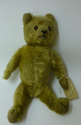 Appraisal: An English pre-war teddy bear covered in gold plush with