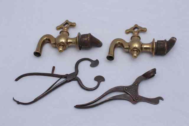 Appraisal: A PAIR OF ANTIQUE BRASS TAPS with stylised handles a