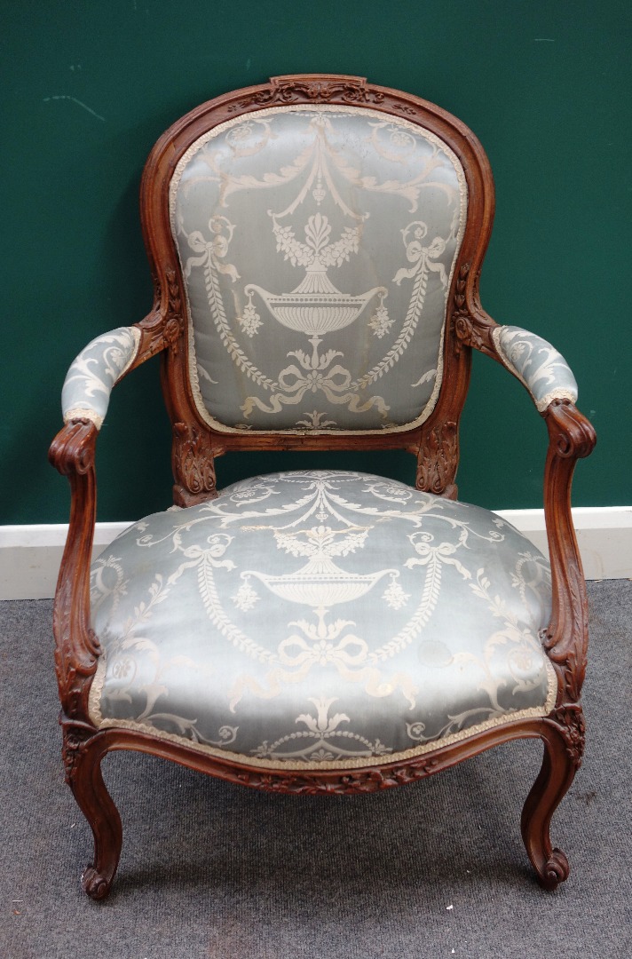 Appraisal: A Louis XV carved beech open arm fauteuil on scroll