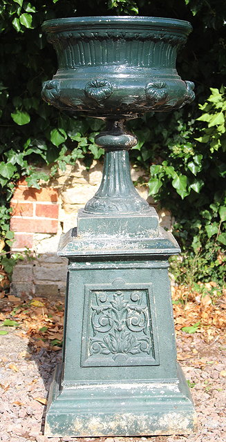 Appraisal: A GREEN PAINTED CAST METAL GARDEN URN with lily flower