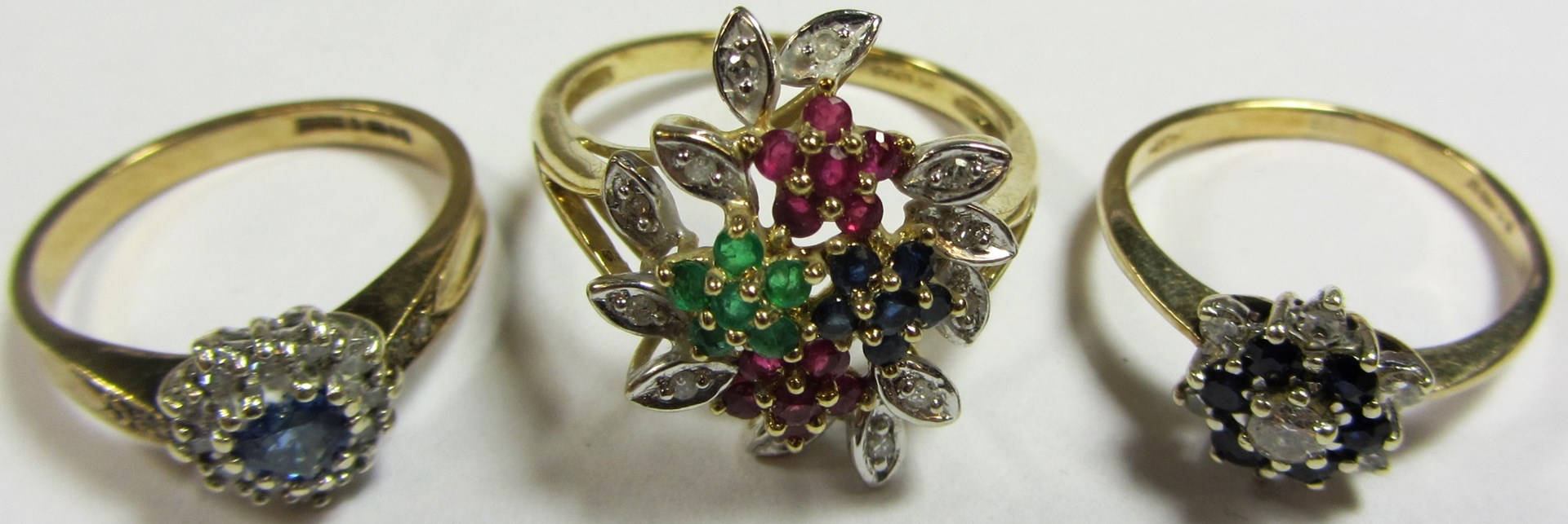 Appraisal: Three gold and gem set cluster rings comprising a ct