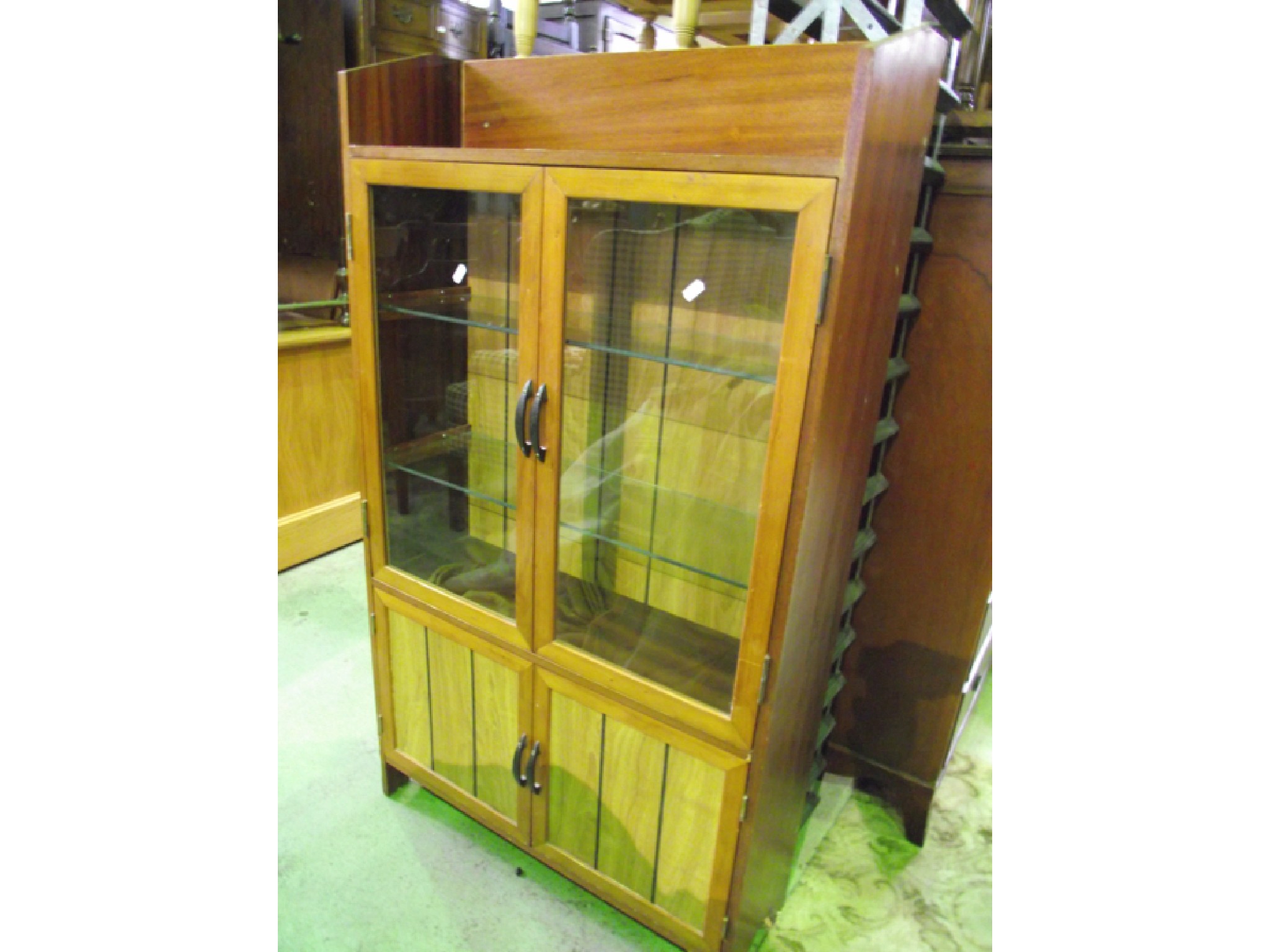 Appraisal: A mahogany bookcase the lower section enclosed by two section