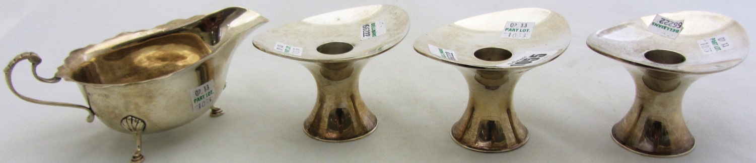 Appraisal: A set of three silver candlesticks with flared oval tops