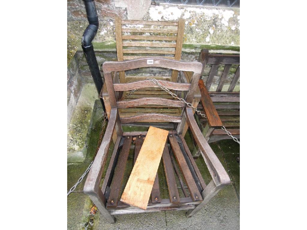 Appraisal: A weathered Arts and Crafts style oak ladderback open elbow