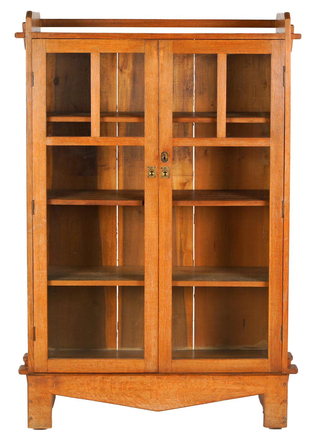 Appraisal: ARTS CRAFTS OAK BOOKCASEunsigned having a pair of glazed hinged