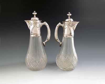 Appraisal: A pair of German silver mounted Art Nouveau claret jugs