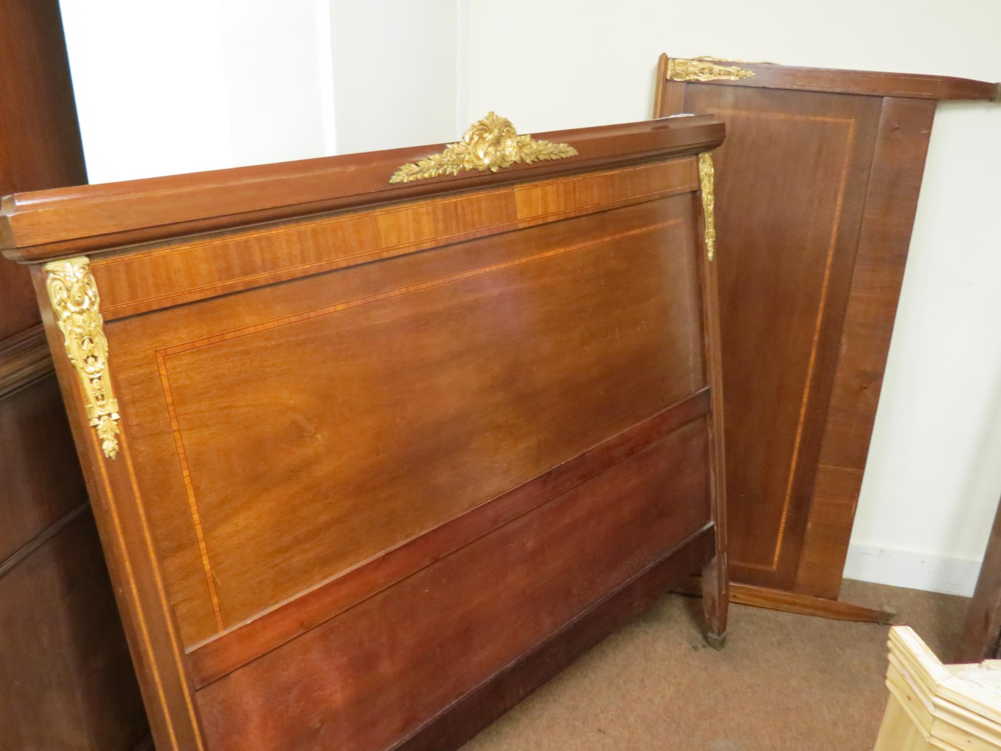 Appraisal: An inlaid mahogany and brass-mounted bedstead double-size with panelled headboard