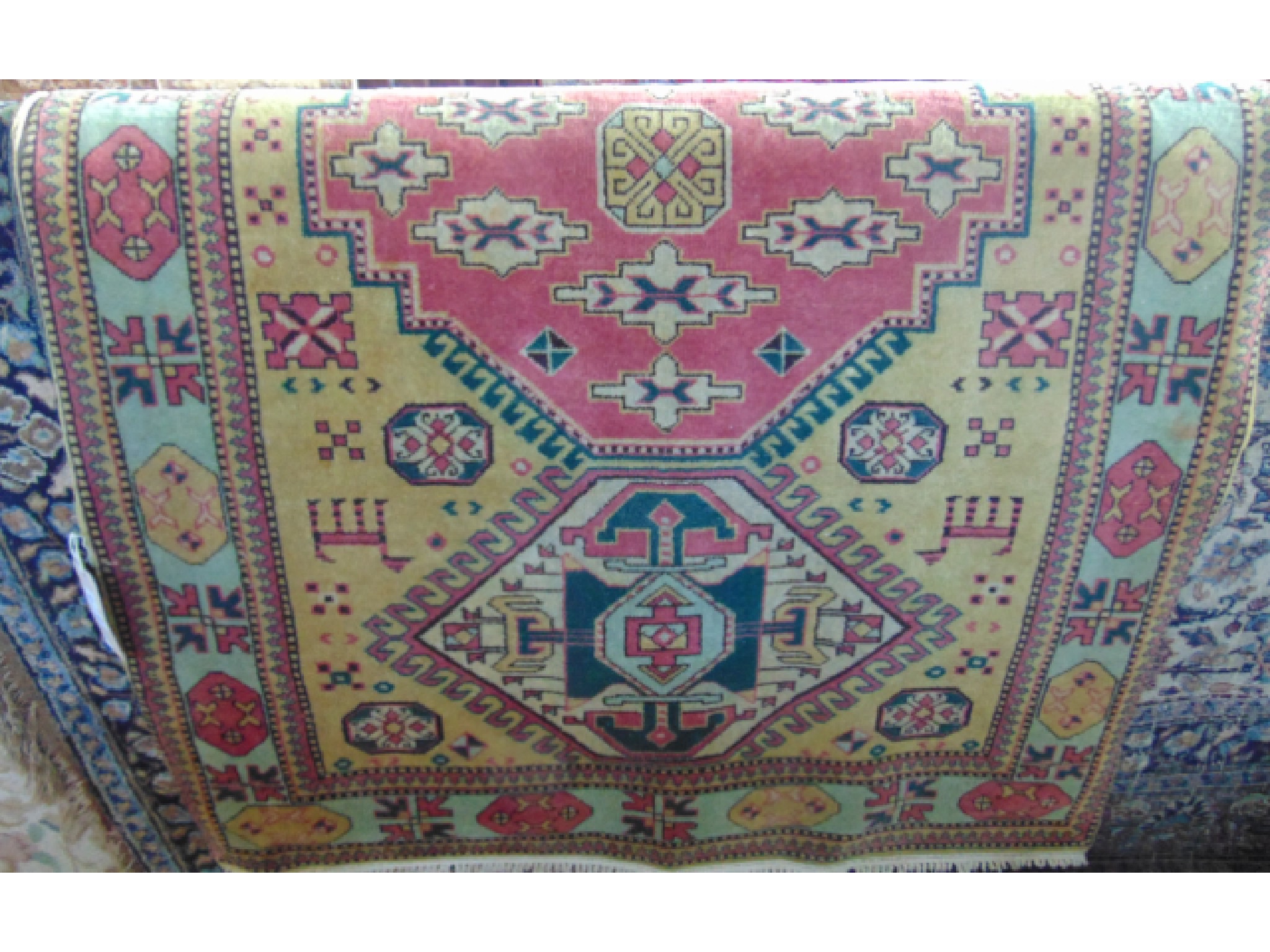 Appraisal: A Persian style wool work rug with a central pink