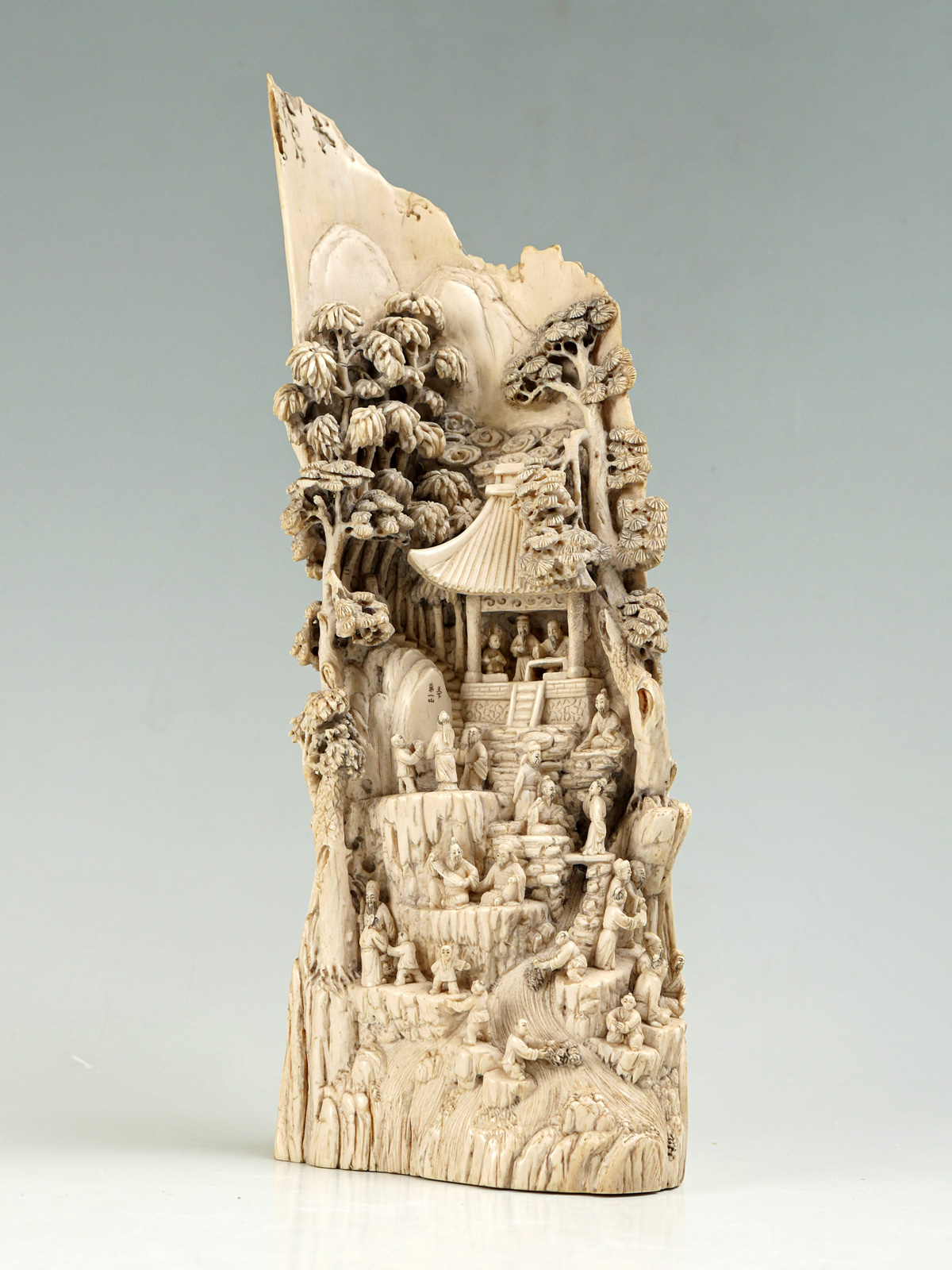 Appraisal: ELABORATELY CARVED IVORY JAPANESE VILLAGE CARVING Tall extensive high relief