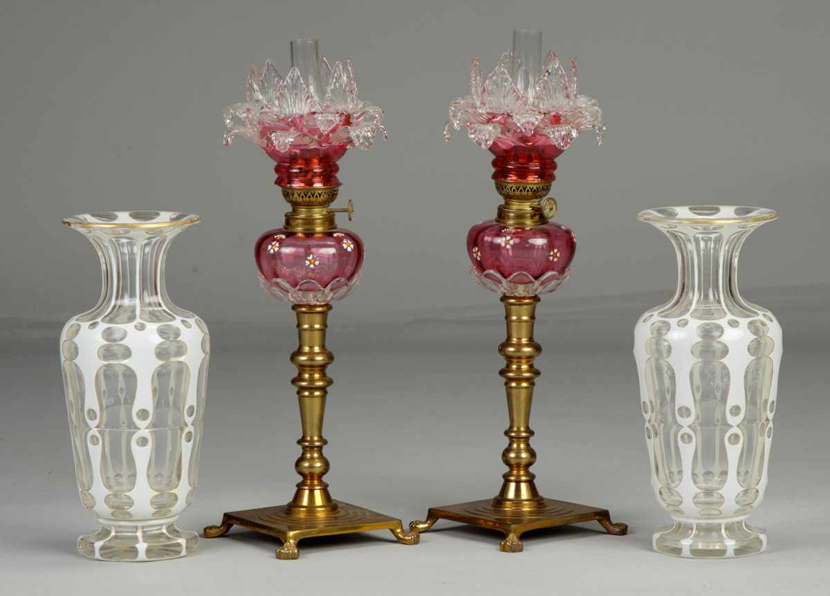 Appraisal: Victorian Cranberry Peg LampsFooted brass base Condition Some minor nicks