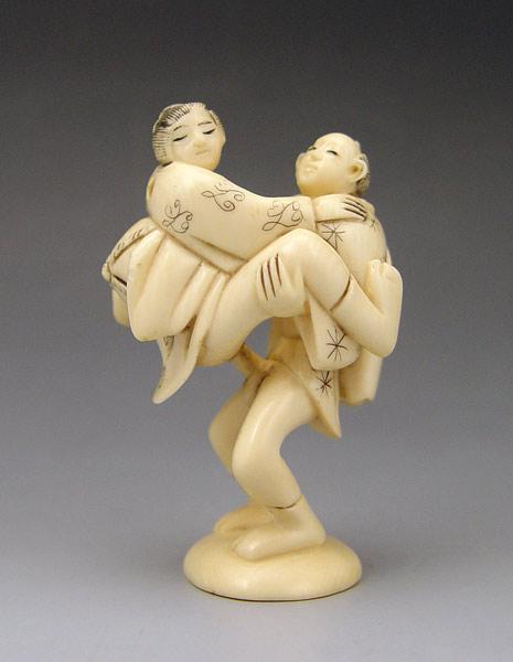 Appraisal: CARVED EROTIC IVORY STANDING COUPLE NETSUKE Couple in erotic standing