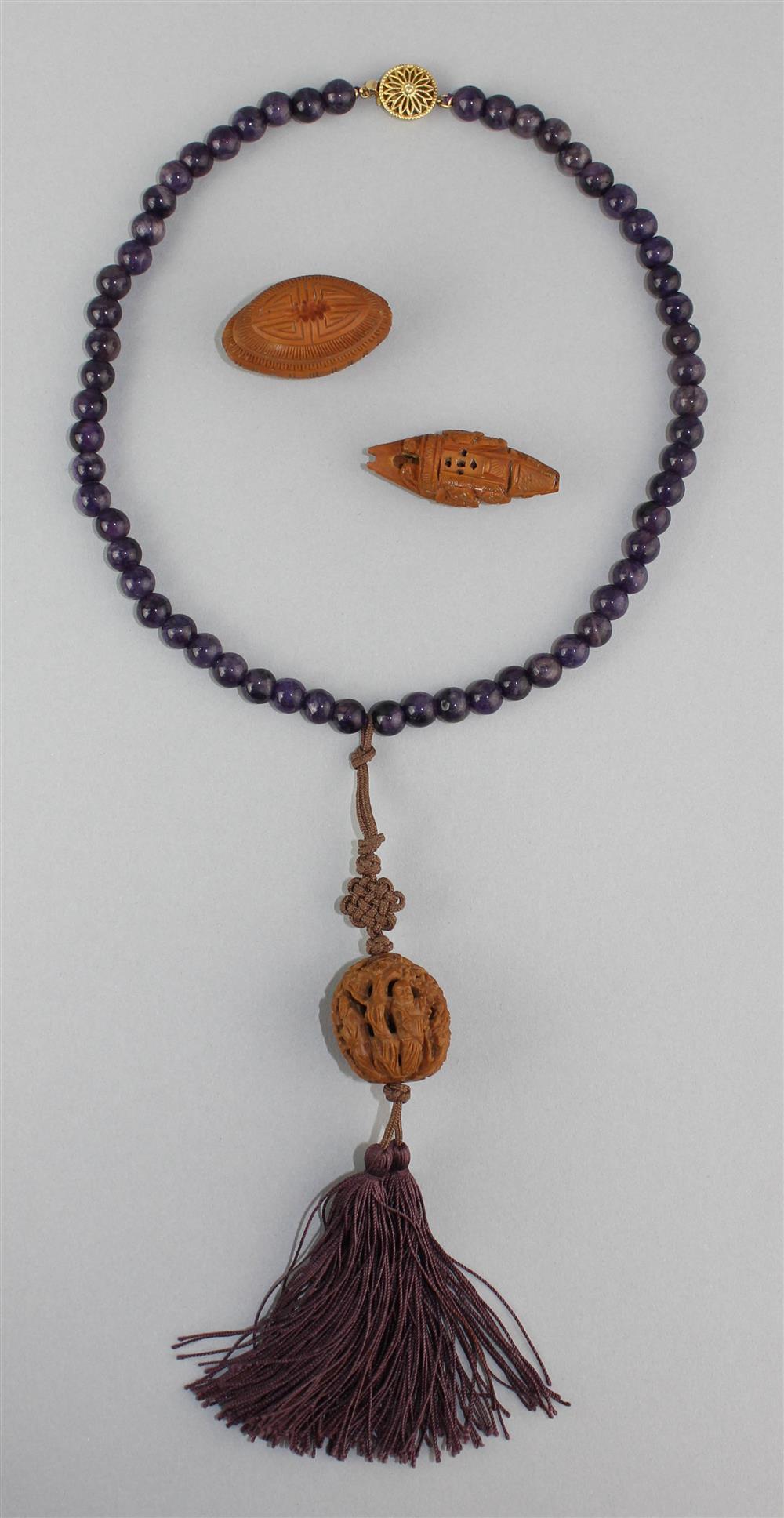 Appraisal: CHINESE AMETHYST BEAD NECKLACE WITH CARVED NUT AND SILK CORD