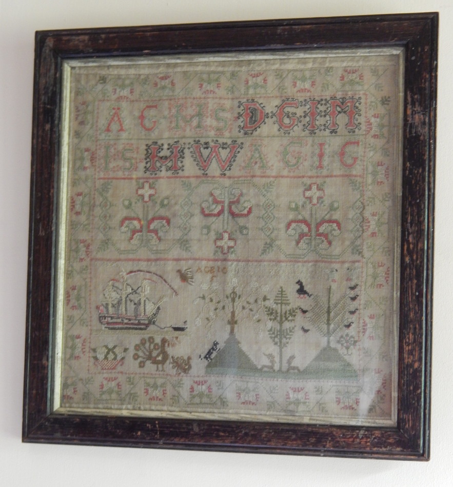 Appraisal: A thC alphabetic and pictorial sampler decorated with trees ship