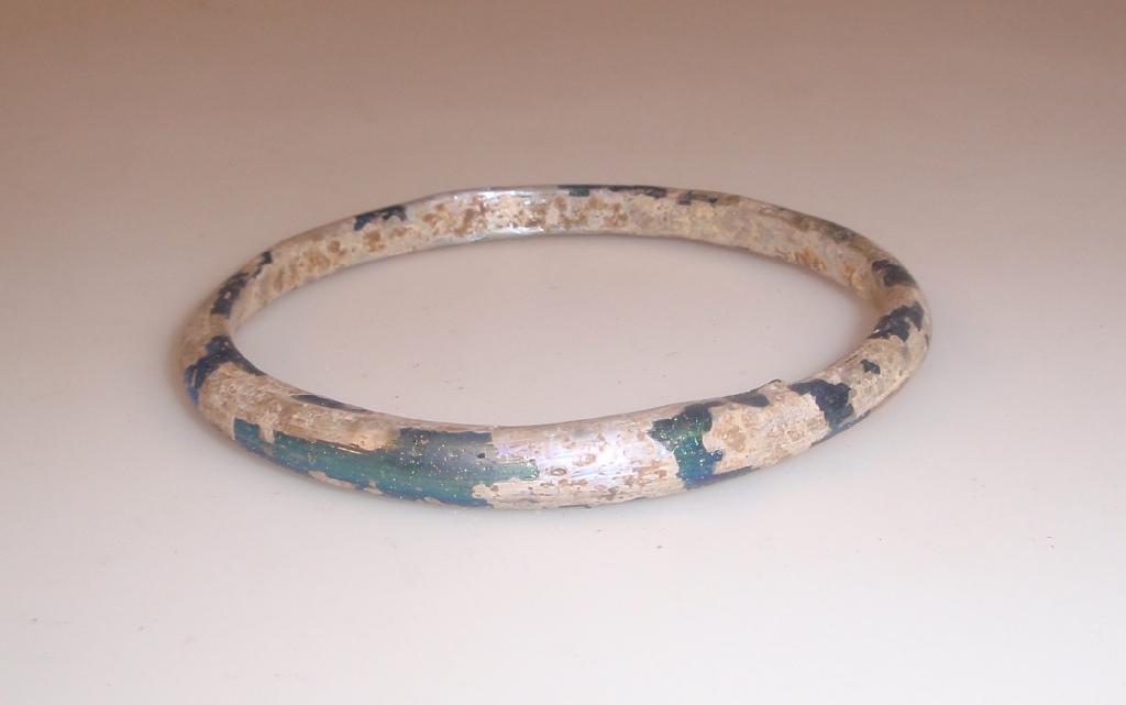 Appraisal: An iridescent Byzantine glass bangle appearing black th- th century