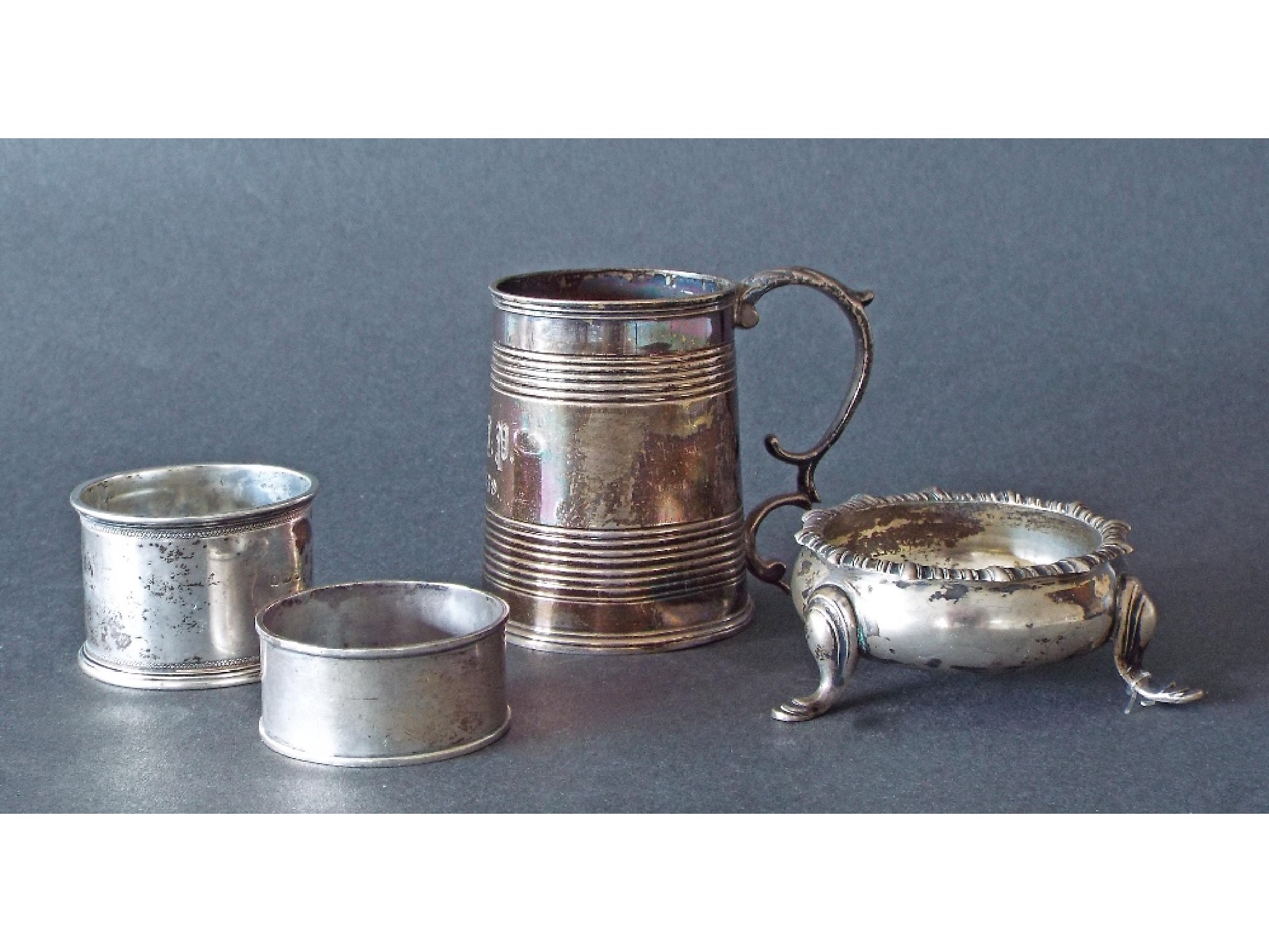 Appraisal: Victorian silver christening tankard silver table salt and two napkin