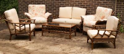 Appraisal: A wicker garden furniture suite with cushions comprising a settee