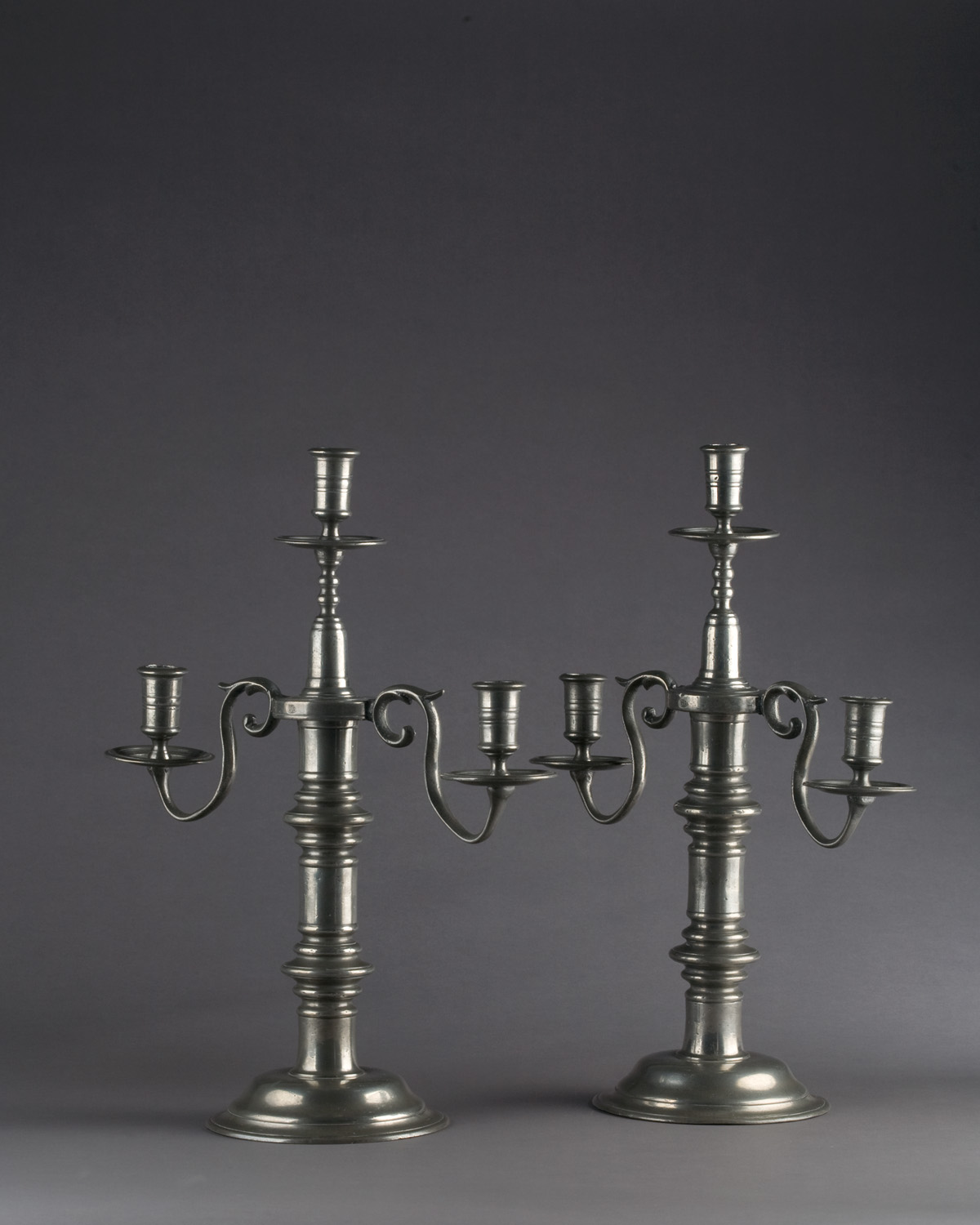 Appraisal: PAIR OF ENGLISH PEWTER THREE-LIGHT CANDELABRA NINETEENTH CENTURY Each turned