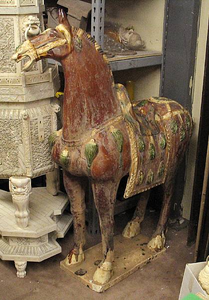 Appraisal: A Tang style sancai glazed pottery horse the glazed surfaces