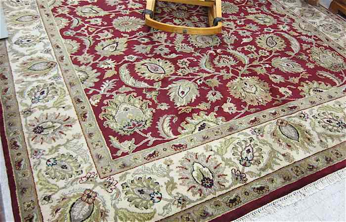 Appraisal: HAND KNOTTED ORIENTAL CARPET Indo-Persian overall foliate design on madder