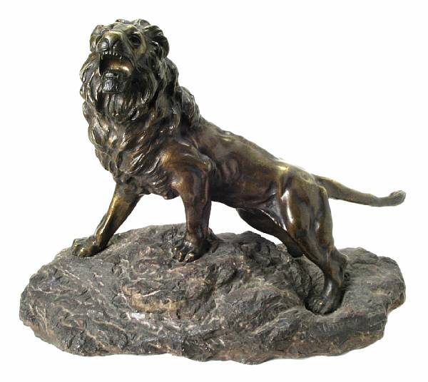 Appraisal: A patinated bronze model of a lion on a carved