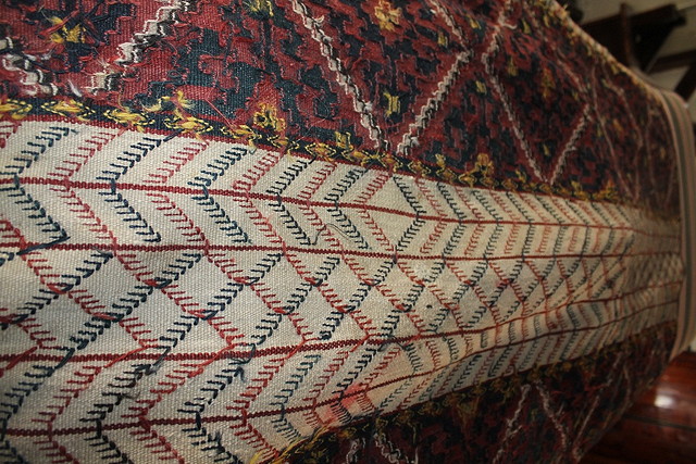 Appraisal: A FLAT WEAVE PROBABLY KELIM RED GROUND RUG with bands