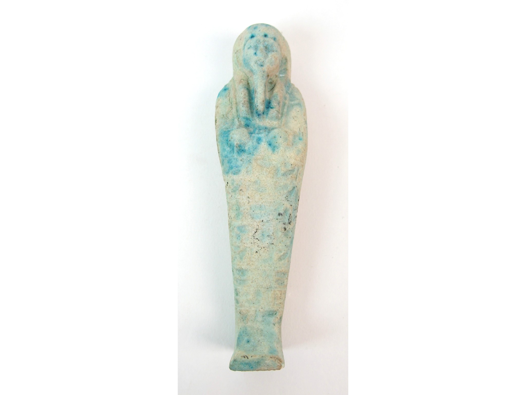 Appraisal: An Egyptian shabtiwith moulded hieroglyphs and with blue tints cm