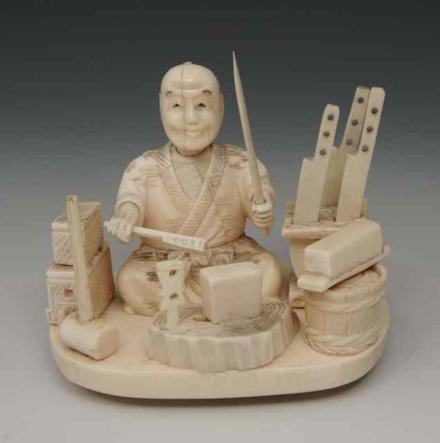 Appraisal: A JAPANESE IVORY CARVED MODEL of a knife vendor with