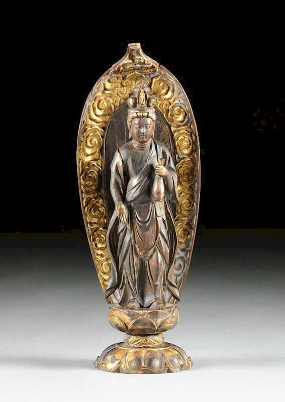 Appraisal: A SOUTH EAST ASIAN PARCEL GILT CARVED WOOD FIGURE OF