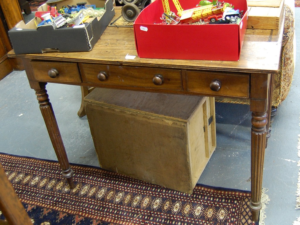 Appraisal: Regency mahogany writing table with three frieze drawers on turned