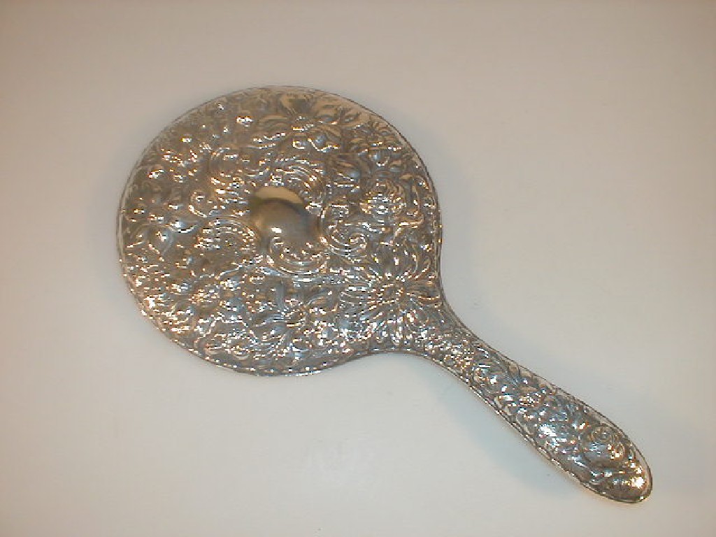 Appraisal: An Edward VII silver backed hand mirror embossed with flowers