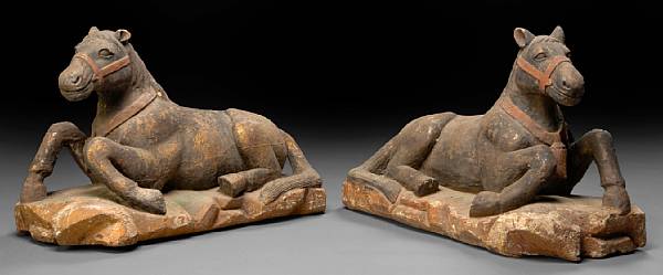 Appraisal: A pair of polychrome decorated carved hardwood models of recumbent