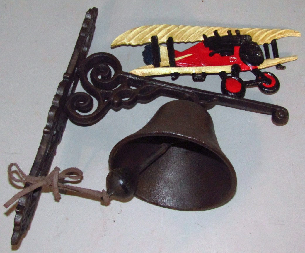 Appraisal: A modern house bell surmounted by Red Baron plane with