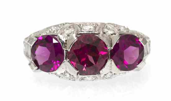 Appraisal: A Platinum Diamond and Garnet Ring containing three round brilliant