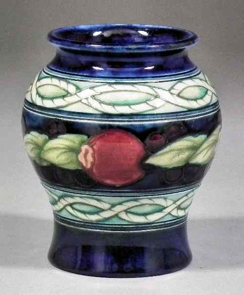 Appraisal: A Moorcroft pottery miniature vase finely tube lined and decorated