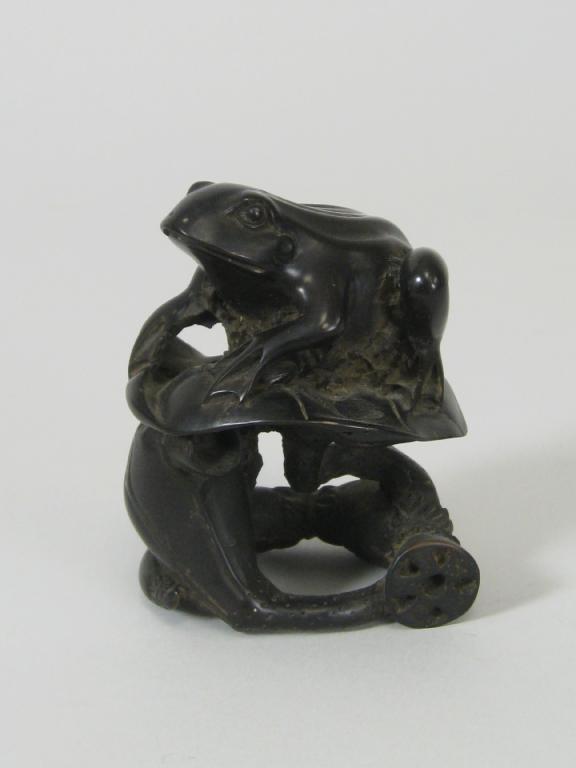 Appraisal: A Japanese carved wooden frog on a lily