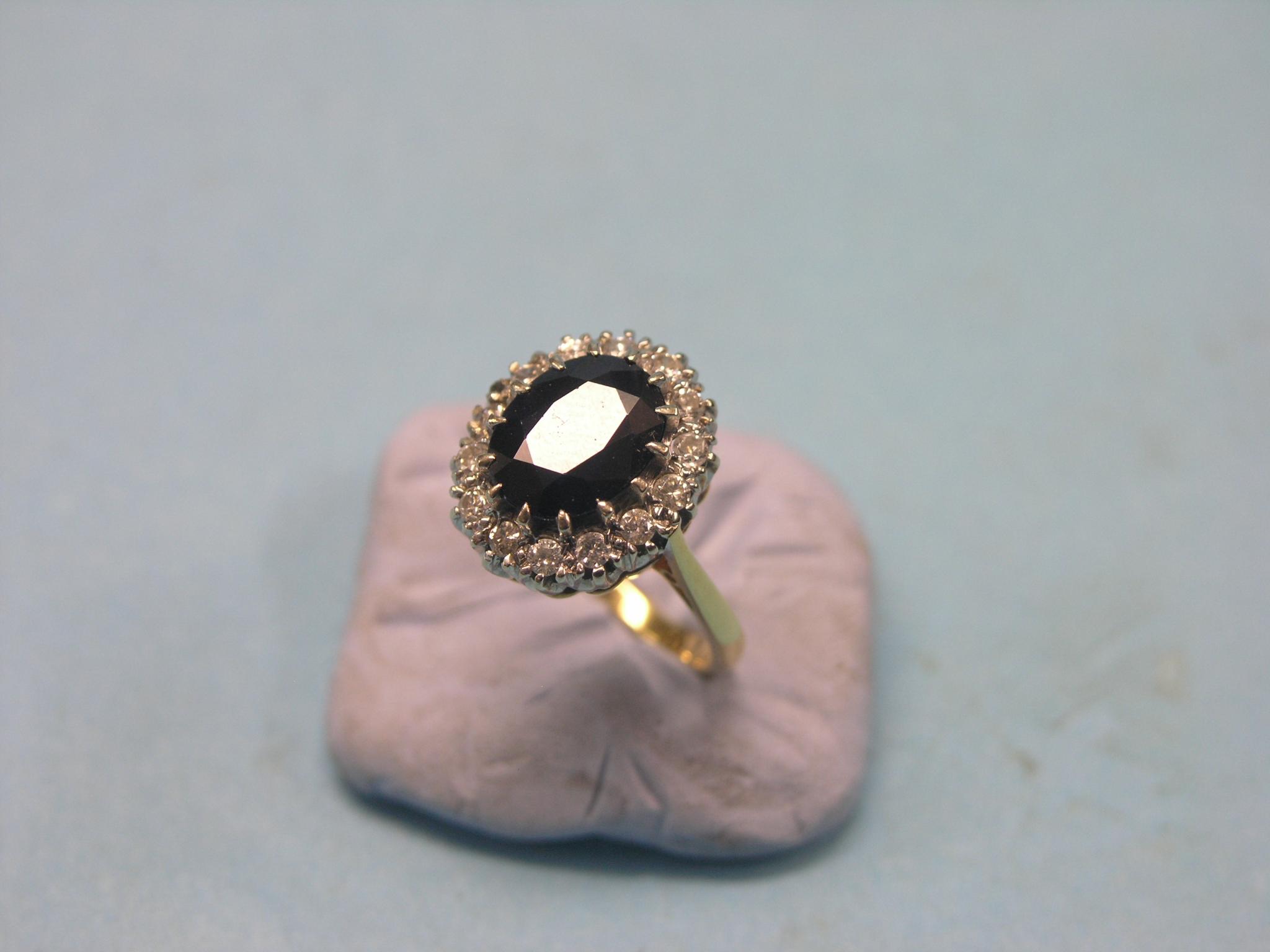 Appraisal: A gold sapphire and diamond-chip ring large faceted sapphire surrounded