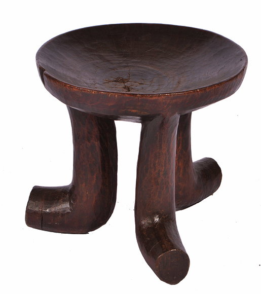 Appraisal: A CIRCULAR AFRICAN HARDWOOD STOOL with dished top and three