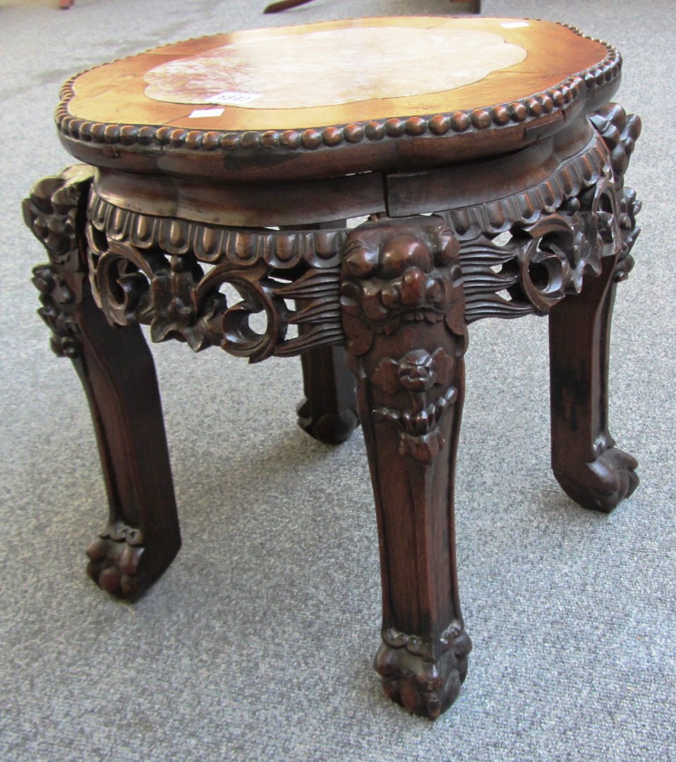 Appraisal: An early th century Chinese hardwood low oval stand with