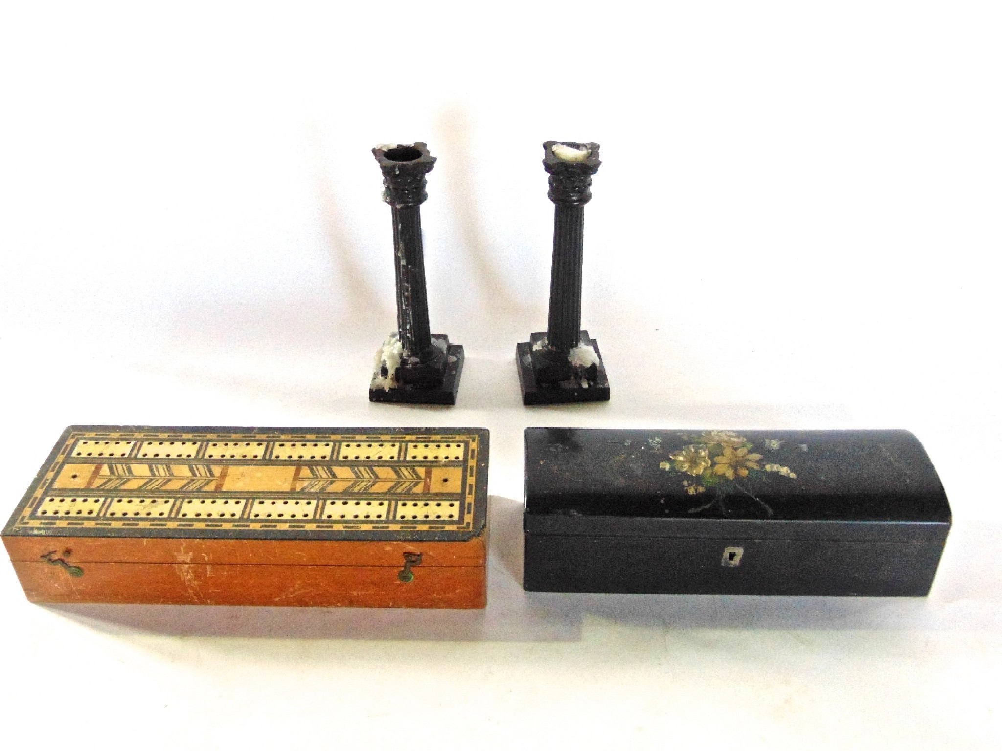 Appraisal: A weighted pair of cast bronze candlesticks in the form