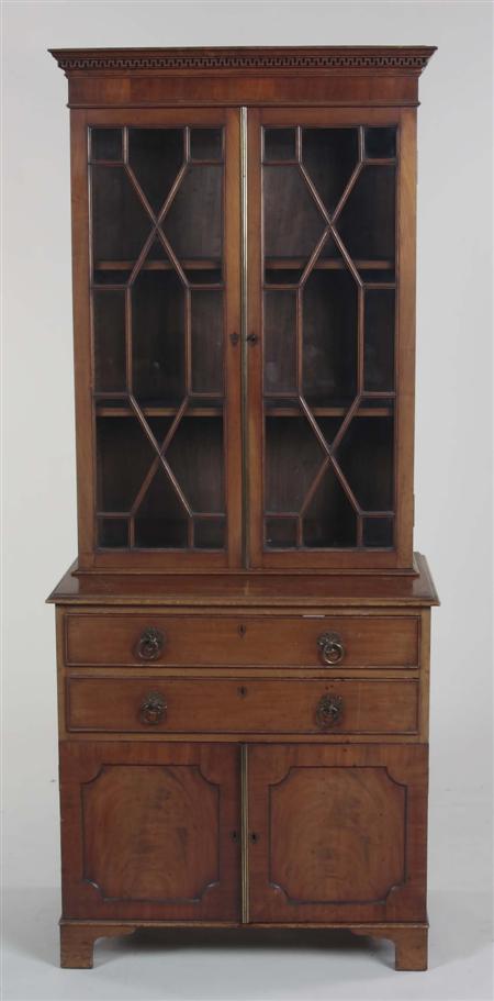 Appraisal: A George III style mahogany bookcase cabinet the projected Greek