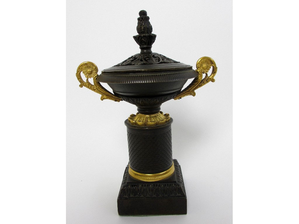 Appraisal: A bronze and gilt metal two handled incense burner and