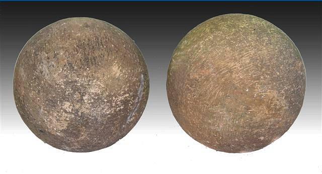 Appraisal: A PAIR OF LARGE STONE BALLS with rough cut edge