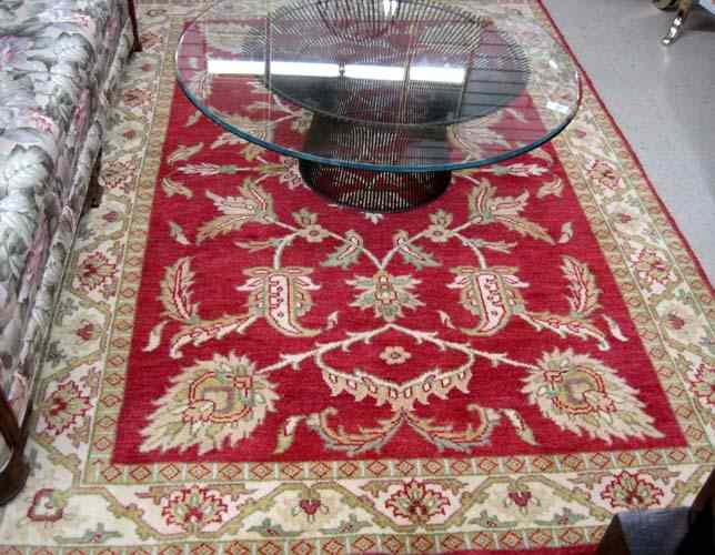 Appraisal: HAND KNOTTED ORIENTAL CARPET Indo-Persian overall foliate design on red